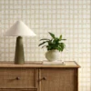 yellow checked wallpaper and wall with cabinets and vases