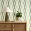 green striped wallpaper and wall with cabinets and vases