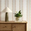 brown striped wallpaper and wall with cabinets and vases