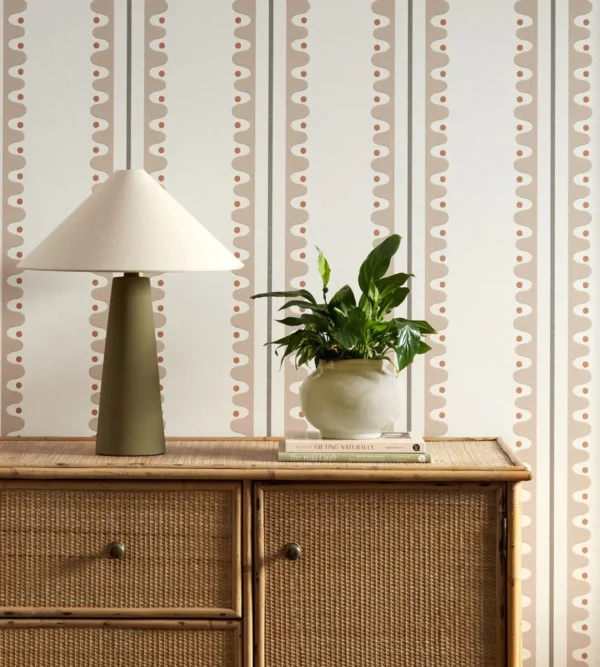 Oakham Wallpaper - Mushroom by brown striped wallpaper and wall with cabinets and vases