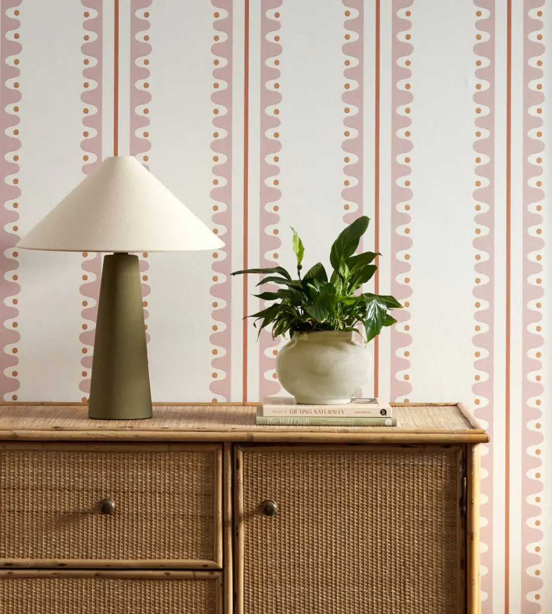 Oakham Wallpaper - Blush by pink striped wallpaper and wall with cabinets and vases