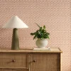 orange striped wallpaper and wall with cabinets and vases