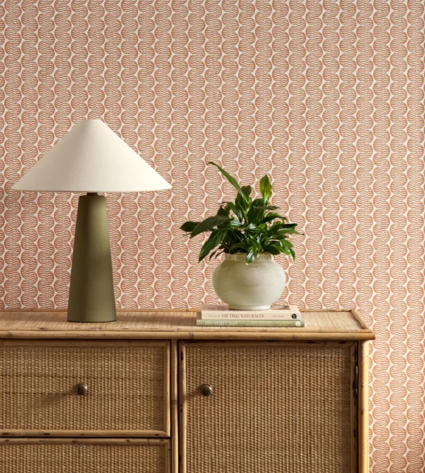 orange striped wallpaper and wall with cabinets and vases