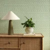 green striped wallpaper and wall with cabinets and vases