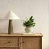 neutral striped wallpaper and wall with cabinets and vases