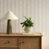 neutral striped wallpaper and wall with cabinets and vases