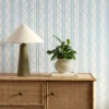 blue striped wallpaper and wall with cabinets and vases
