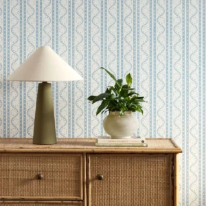 blue striped wallpaper and wall with cabinets and vases