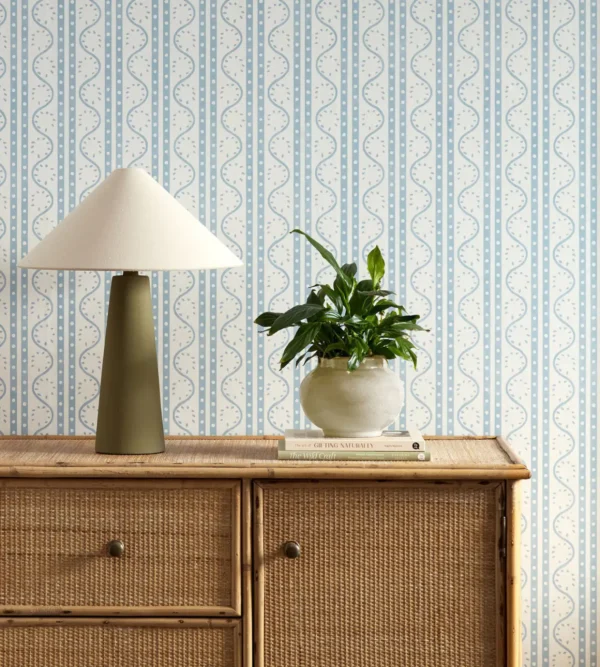 Split Pea Wallpaper - Coast Blue by blue striped wallpaper and wall with cabinets and vases