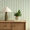 green striped wallpaper and wall with cabinets and vases