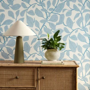 blue botanical wallpaper and wall with cabinets and vases