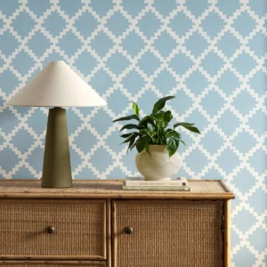 blue geometric wallpaper and wall with cabinets and vases
