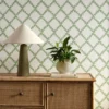 green geometric wallpaper and wall with cabinets and vases