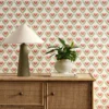 red botanical wallpaper and wall with cabinets and vases