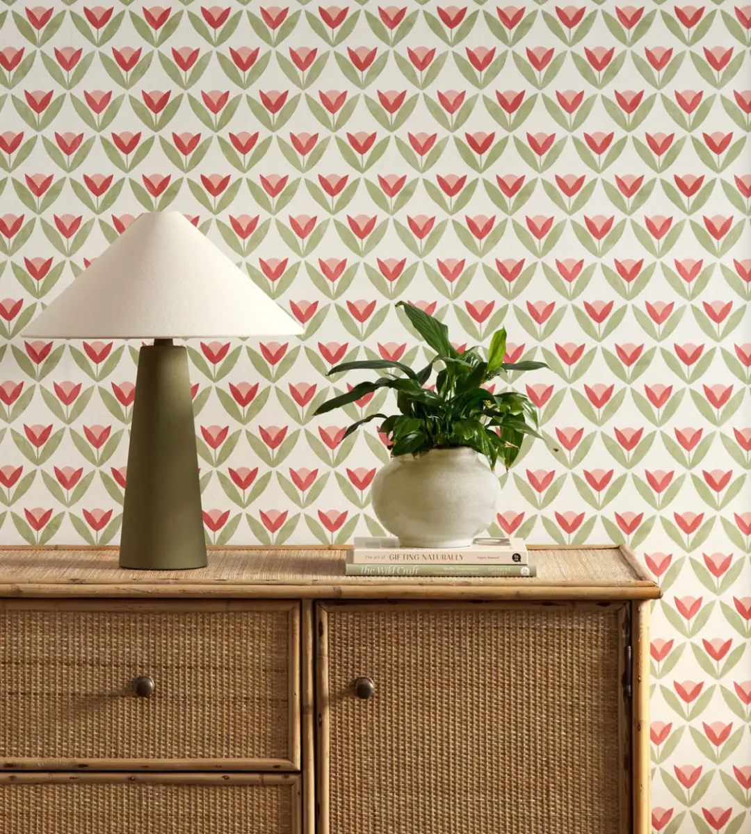 red botanical wallpaper and wall with cabinets and vases