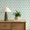 green botanical wallpaper and wall with cabinets and vases
