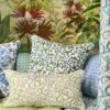green botanical cushion with sofa and wall