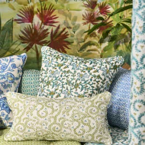 green botanical cushion with sofa and wall