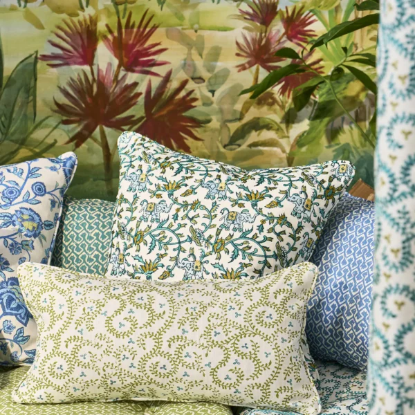 Hathi Embroidery Fabric - Teal by green botanical cushion with sofa and wall