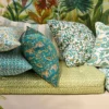 green botanical cushion with sofa and wall