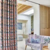 orange geometric curtain with sofa and cushion