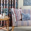 red striped sofa with cushion and curtain