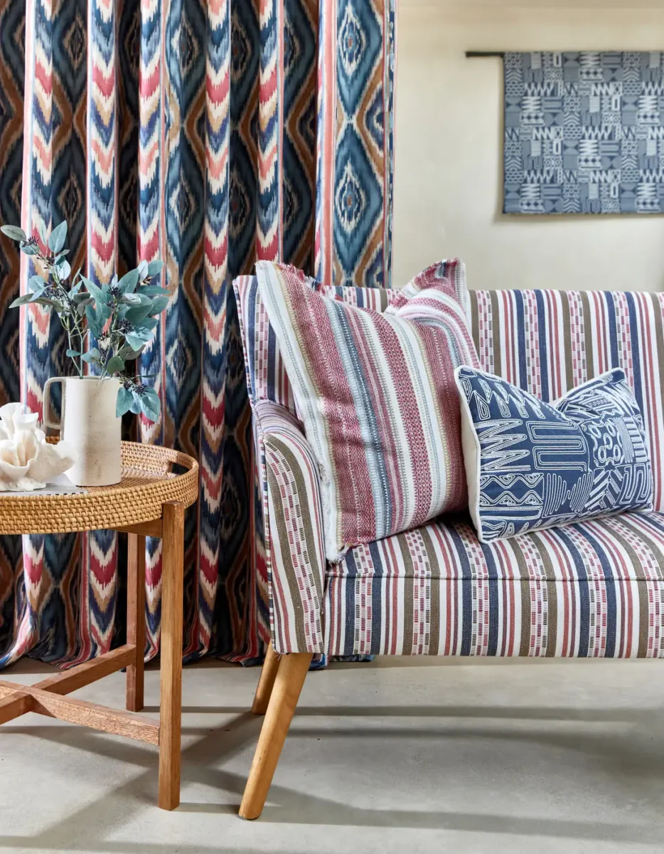 red striped sofa with cushion and curtain