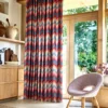 orange geometric curtain with armchair and cabinets