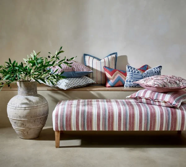 Zola Fabric - Cinnabar by red striped bed with cushion and vases