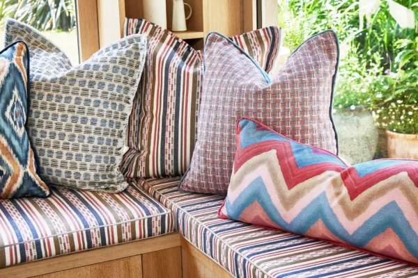 Alora Fabric - Rattan by brown spotted pouf with