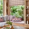 green striped blind with cushion and window