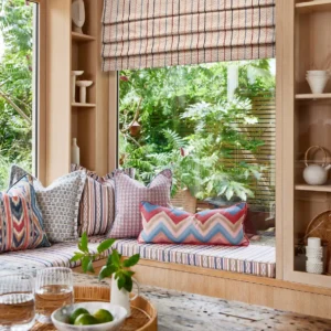 green striped blind with cushion and window