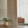 blue geometric curtain with sofa and vases