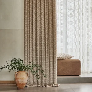 blue geometric curtain with sofa and vases