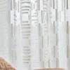 blue geometric curtain with cushion and sofa