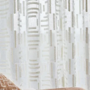 blue geometric curtain with cushion and sofa