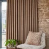 neutral spotted curtain with armchair and vases