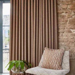 neutral spotted curtain with armchair and vases