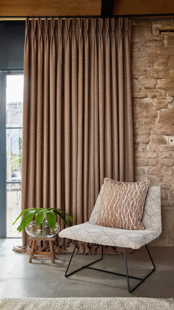 Ava Fabric - Earth by neutral spotted curtain with armchair and vases
