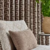 black-grey geometric curtain with armchair and cushion