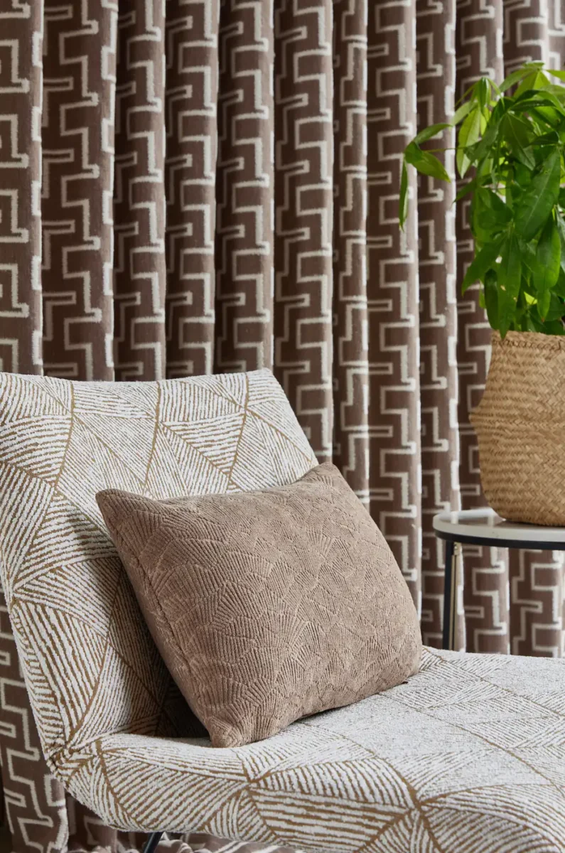 black-grey geometric curtain with armchair and cushion