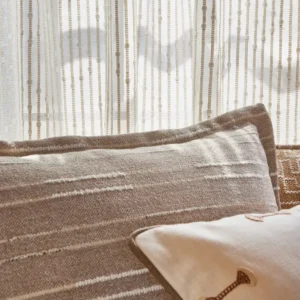 white striped curtain with sofa and armchair