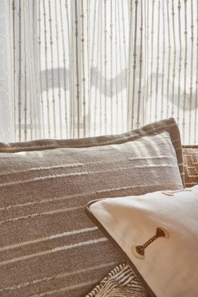 white striped curtain with sofa and armchair