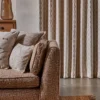 neutral striped curtain with cushion and sofa