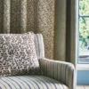blue botanical curtain with cushion and sofa