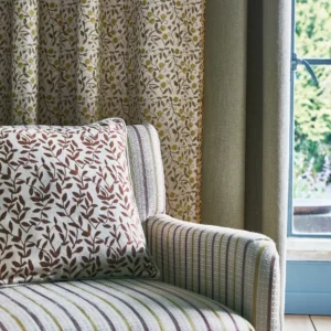 blue botanical curtain with cushion and sofa