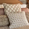 green geometric cushion with armchair and curtain
