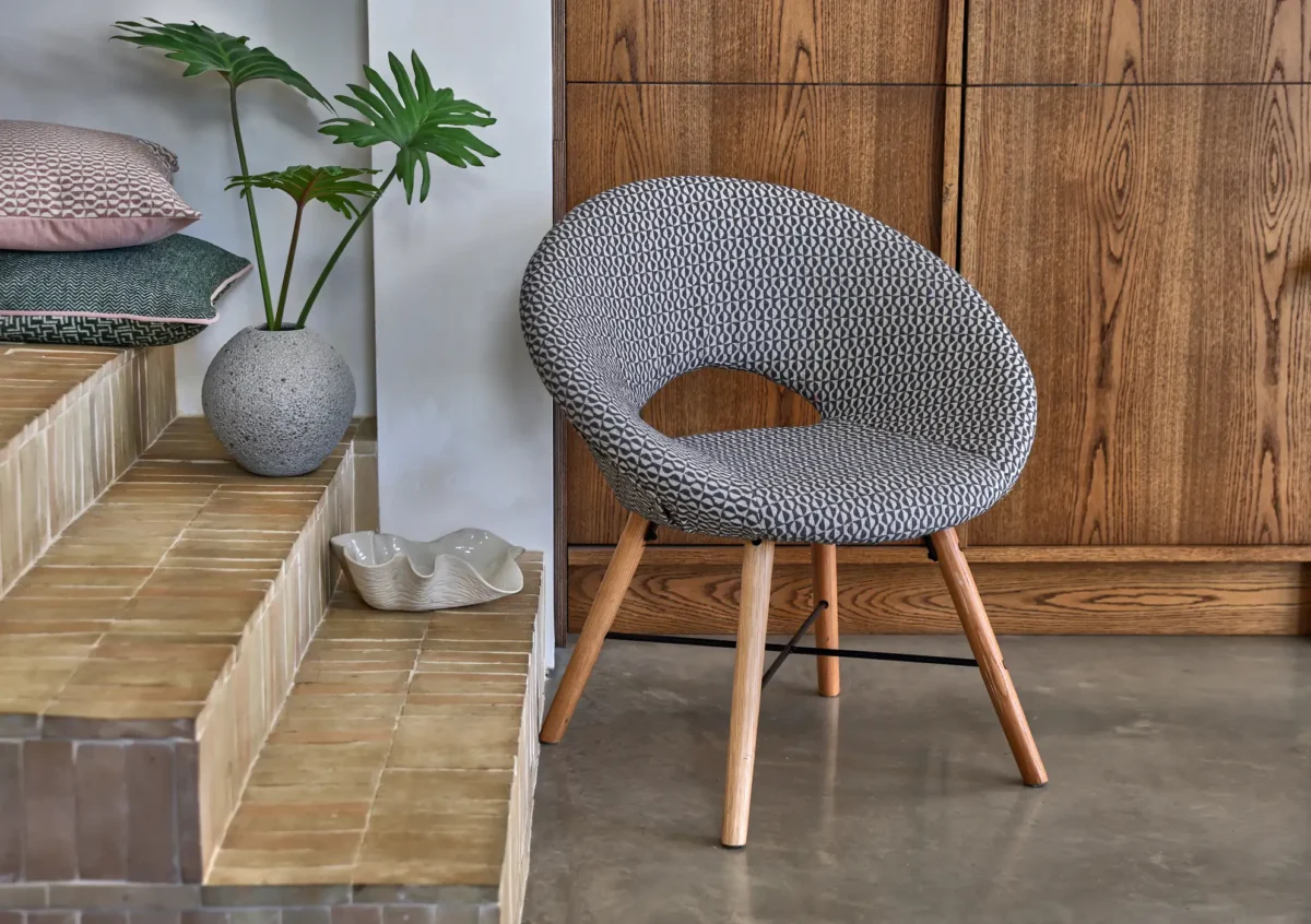 neutral geometric armchair with cushion and vases