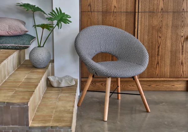 Finsbury Fabric - Jet by neutral geometric armchair with cushion and vases