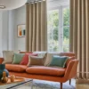 brown misc cushion with curtain and sofa